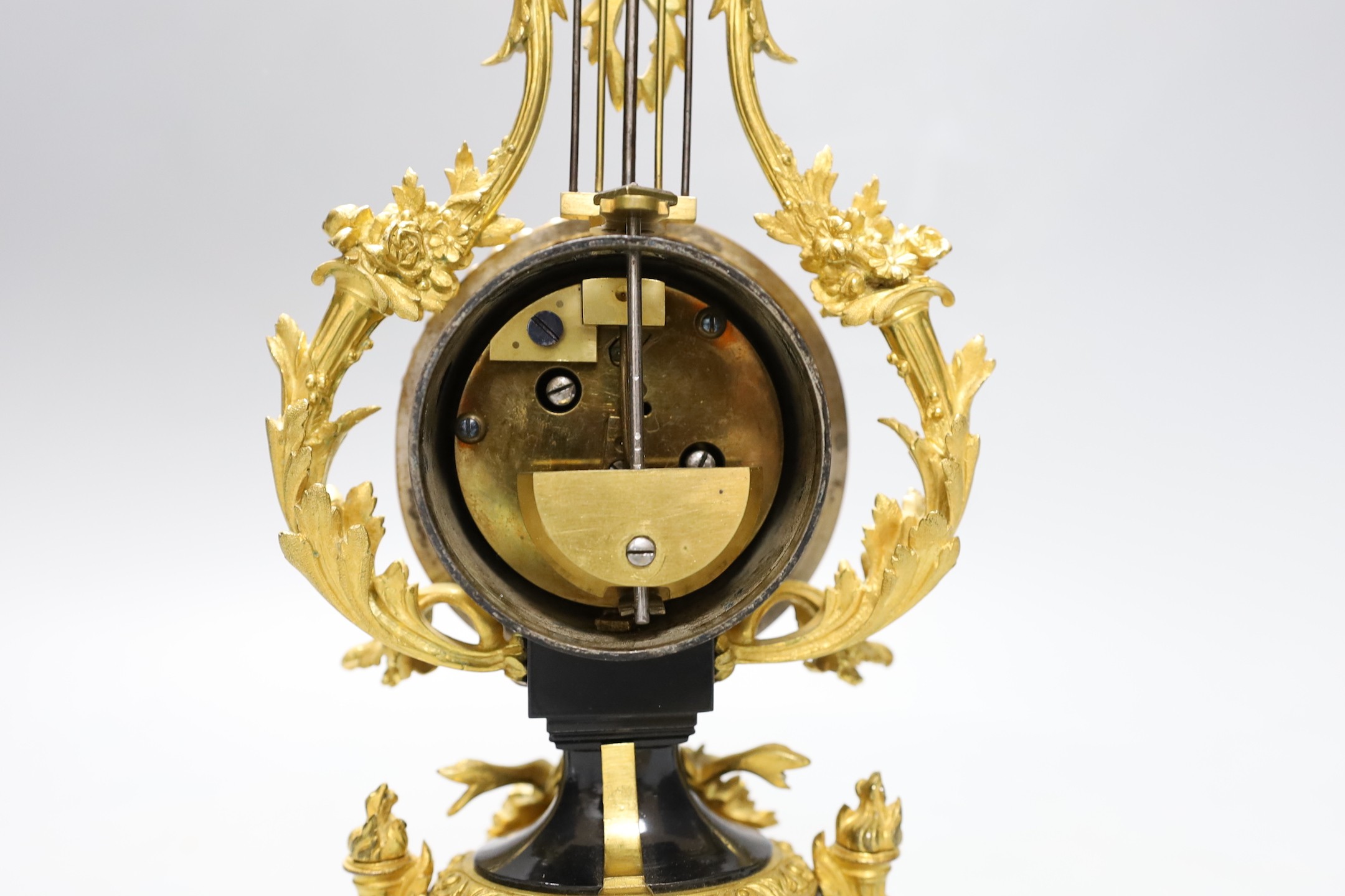 An early 20th century French ormolu mounted miniature lyre clock, 24 cm time